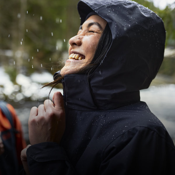Femme avec une veste imperméable sous la pluie