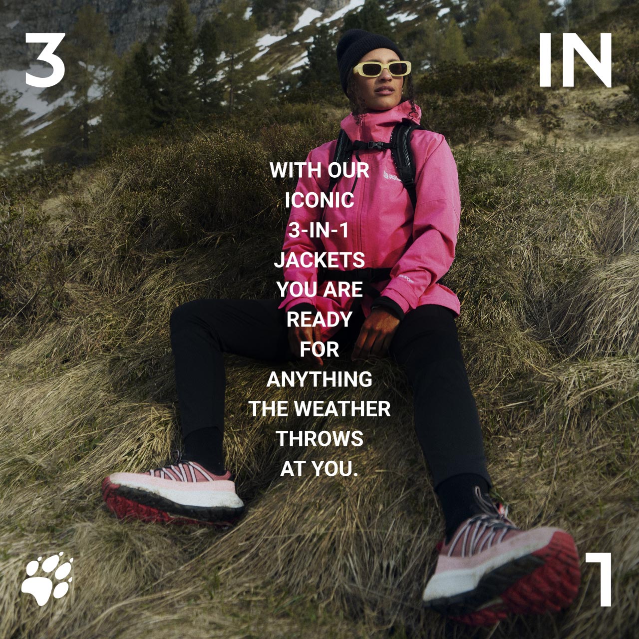 Persoon in roze jack en met muts zittend op een met gras begroeide helling, met zonnebril en wandelschoenen. Tekst: "With our iconic 3-in-1 jackets, you are ready for anything the weather throws at you."